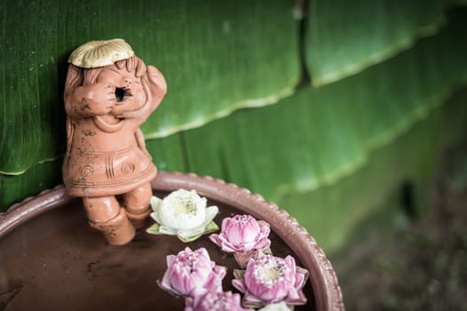 closeup of doll sculpture with pool