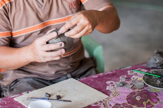 close-up potter's hand, traditional making a cup product