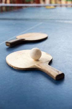 racket of table tennis with white ball