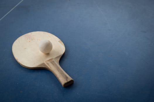 racket of table tennis with white ball