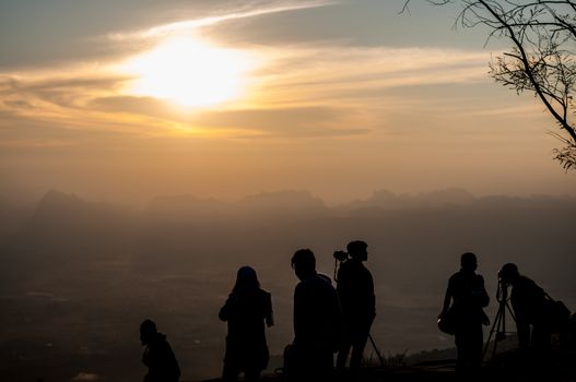 Sunrise landscape on mountain view with traveler and photographer group