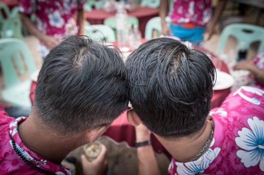 Closeup of two human head collide with each other to see something