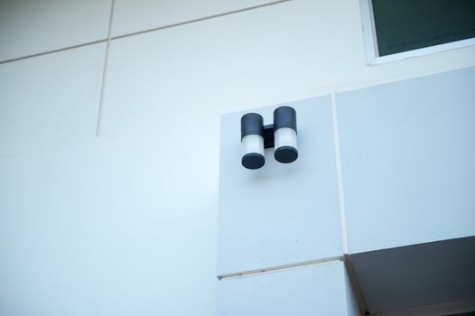 Closeup of electronic lamp design on wall building
