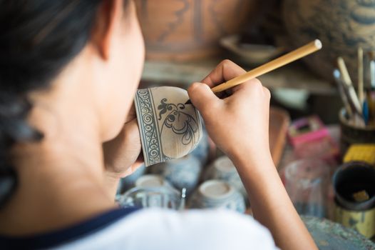 Closeup of people made painting on ceramic cup