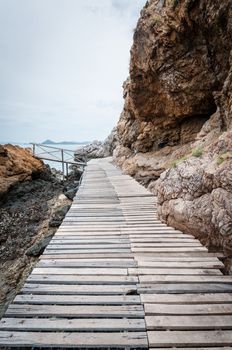 Wooden pathway with rock valley or cliff on the island