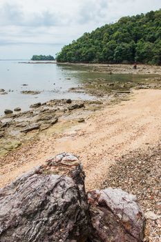 Abstract stone on the beach with mountain landscape