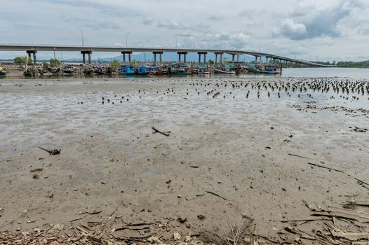 Grunge of sand on the beach with fishing harbor