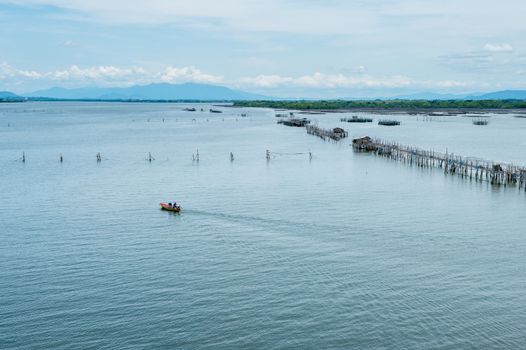 Boat running on the sea with fisherman's farm