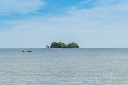 Closeup of island with boat on the ocean