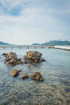 Landscape of rock in the ocean with bridge