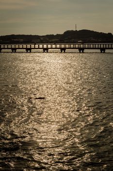 Landscape of sunlight reflection on the sea with bridge