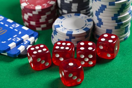 Red Dice and Casino Chips on Green Poker Table