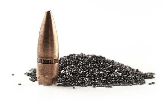 Bullet and gunpowder isolated on white background with shadow