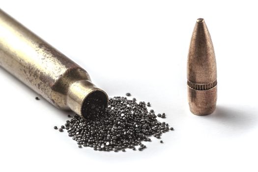 Bullet and gunpowder isolated on white background with shadow