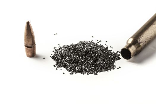 Bullet and gunpowder isolated on white background with shadow