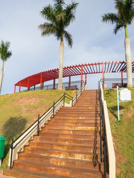 Guararema, São Paulo, Brazil, stairs of the Mirante of the city with gardens and palm trees in day of sun.