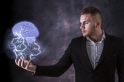 Business Man holding a brain in lighning