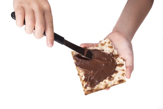 Small Child Hands Making Chocolate on Matzah Passover Treat