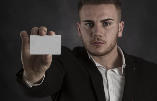 Young Man in Suit Holding Blank White Businesscard