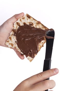 Child hand Macking Chocolate With Matzah for Passover