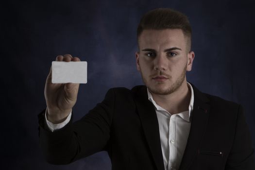 Young Man in Suit Holding Blank White Businesscard