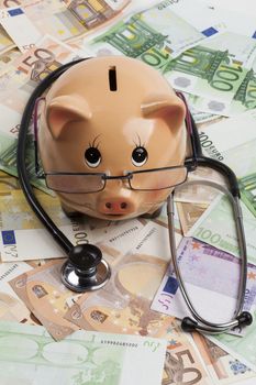 Piggy Bank With Black Stethoscope on Euro Banknotes . European Health Insurance Costs