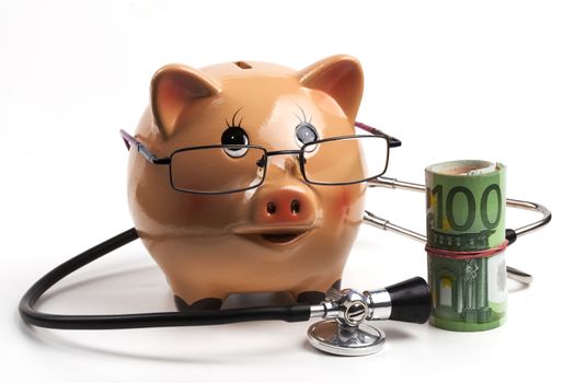 Piggy Bank With Black Stethoscope and Euro Banknotes Roll Isolated on White Background. European Health Insurance Costs