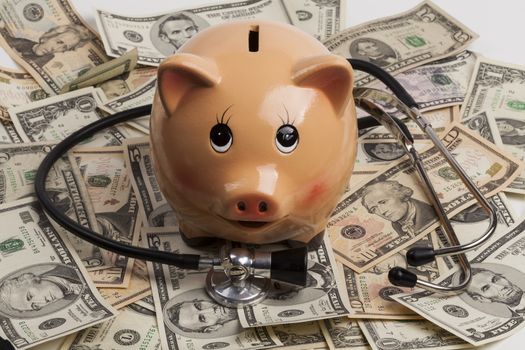 Piggy Bank With Black Stethoscope on Dollar Banknotes 