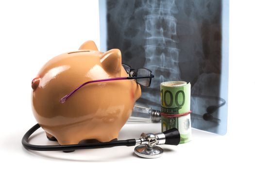 Piggy Bank With Black Stethoscope and Euro Banknotes Roll Isolated on White Background. European Health Insurance Costs