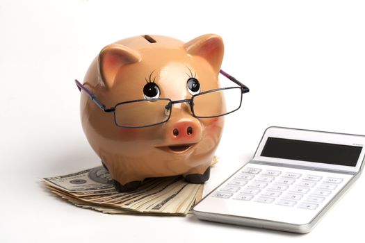 Piggy Bank With Dollars and Calculator Isolated on White Background