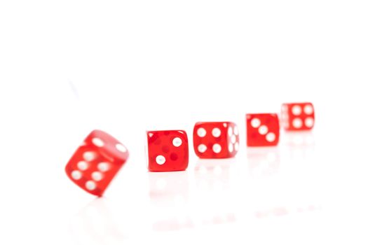 Red Casino Dices in a Row on White Background With Some Movement