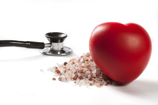 Himalayan Salt Raw Crystals With Red Heart and Black Stethoscope Isolated on White Background