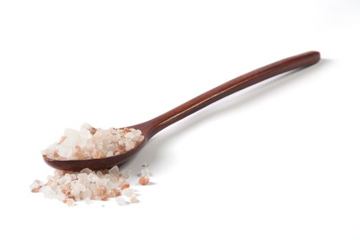 Himalayan Salt Raw Crystals Pile with Brown Wood Spoon Isolated on White Background