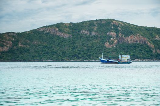 Closeup of boat on the beach with mountain island