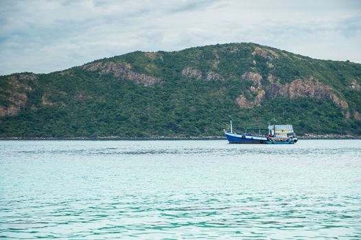 Closeup of boat on the beach with mountain island