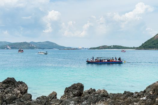 Closeup of boat on the beach with mountain island