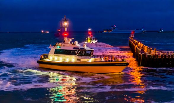 The harbor of Vlissingen at night, illuminated boats sailing on the sea, Zeeland, The Netherlands