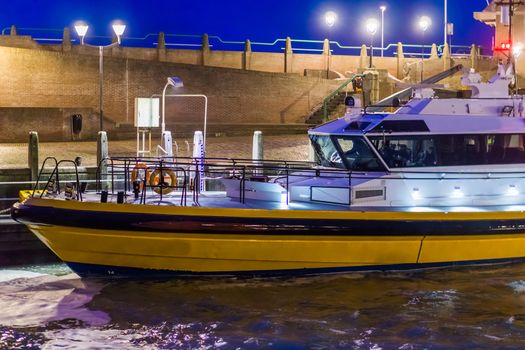 docked modern lighted boat, in the port of Vlissingen at night, Zeeland, The Netherlands