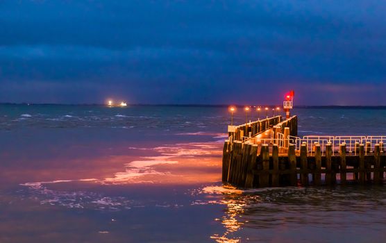 The pier jetty of vlissingen at night, the harbor lighted in the dark, Zeeland, the Netherlands