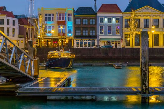 beautiful view on the city of vlissingen at night from the docks, a lighted boat and buildings, popular city of zeeland, the Netherlands