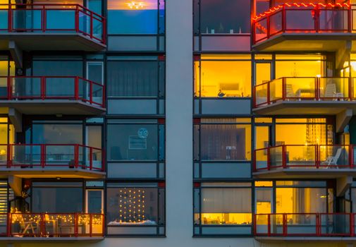 balconies with lighted windows, Apartment complex at night, typical dutch architecture