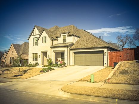 Vintage tone image a brand new construction single-family house with attached garage near Dallas, Texas, USA