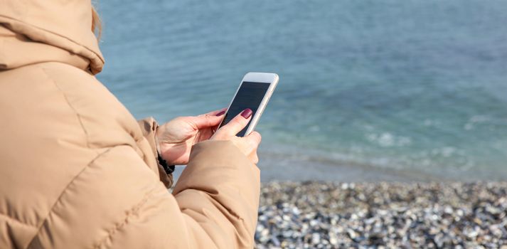 Beautiful Woman Using Smart Phone On A Beach