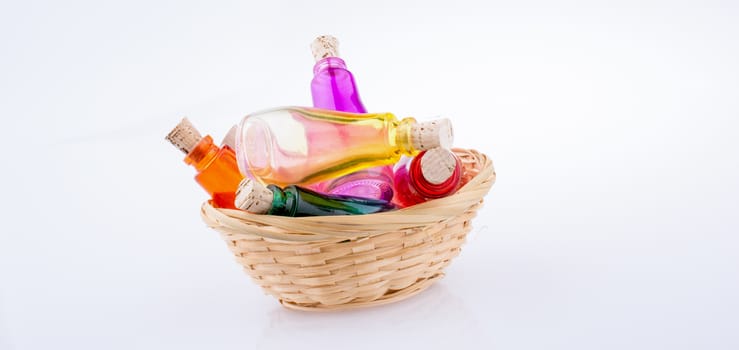 Set of Empty small  transparent bottles in a straw basket