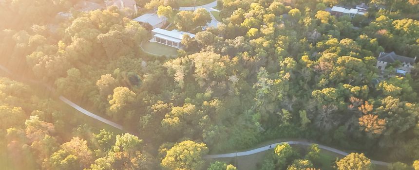 Panorama aerial drone view Kessler Park located just south of downtown Dallas, Texas, USA. Flyover nature area with mature trees and rolling hill terrain