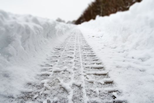 Image of car tracks in white snow in Bavaria, Germany in winter