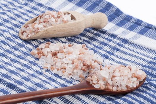 Himalayan Salt Raw Crystals in Two Wood Spons on Blue Ktchen Cloth Background