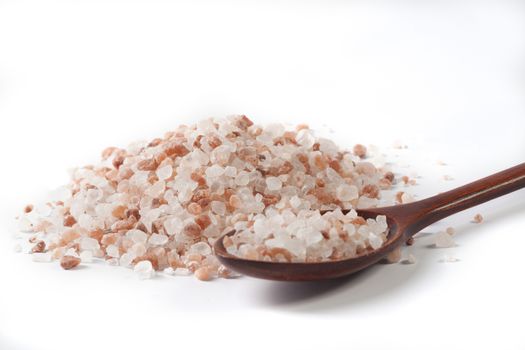 Himalayan Salt Raw Crystals Pile with Brown Wood Spoon Isolated on White Background