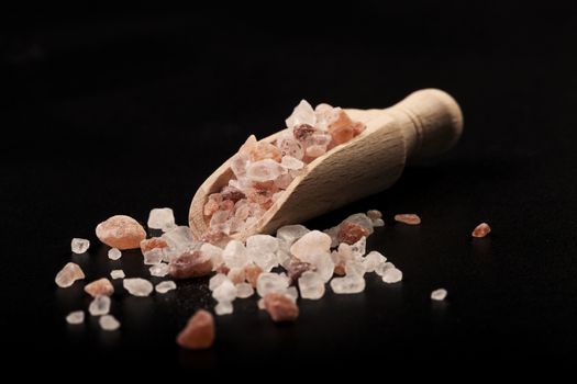 Wood Spice Spoon with Himalayan Salt Crystals on Black Background