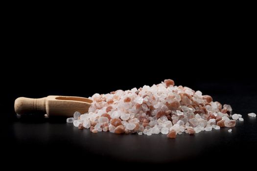 Brown Wood Spice Spoon With Hymalaian Salt Crystals on Black Background
